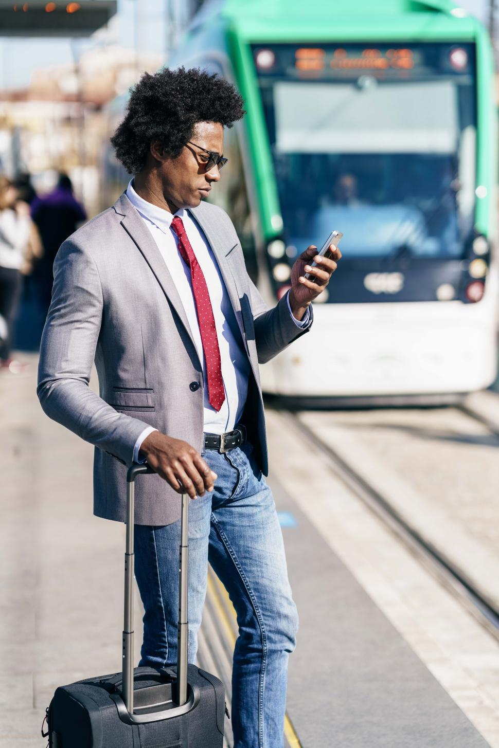 Free Image of Black Businessman waiting for the next train 
