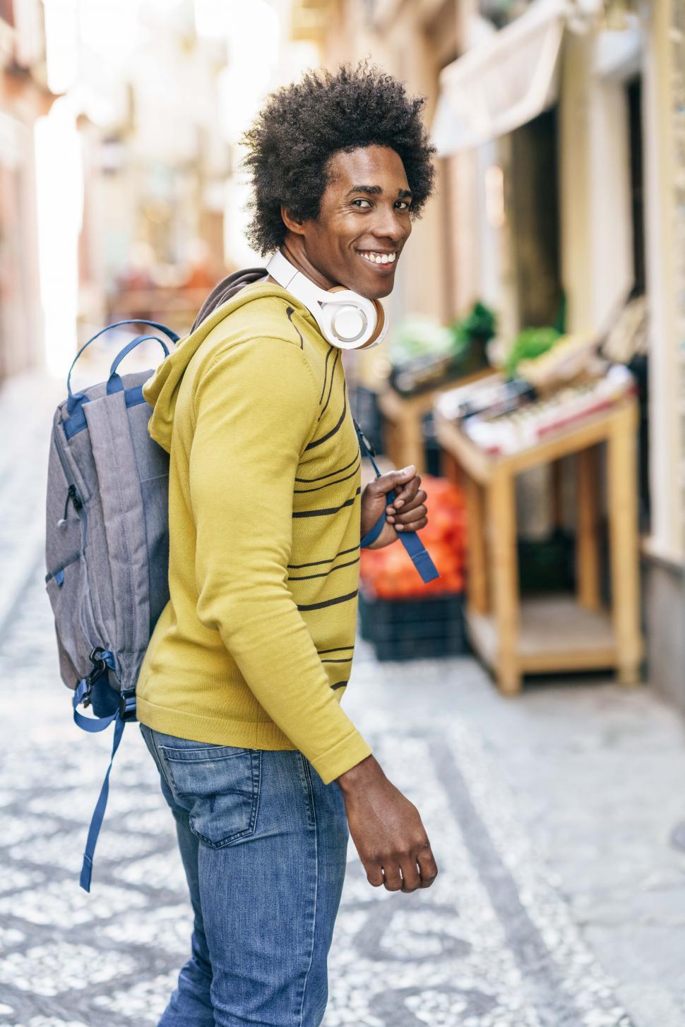 Free Image of Black man with wireless headphones sightseeing in Granada 