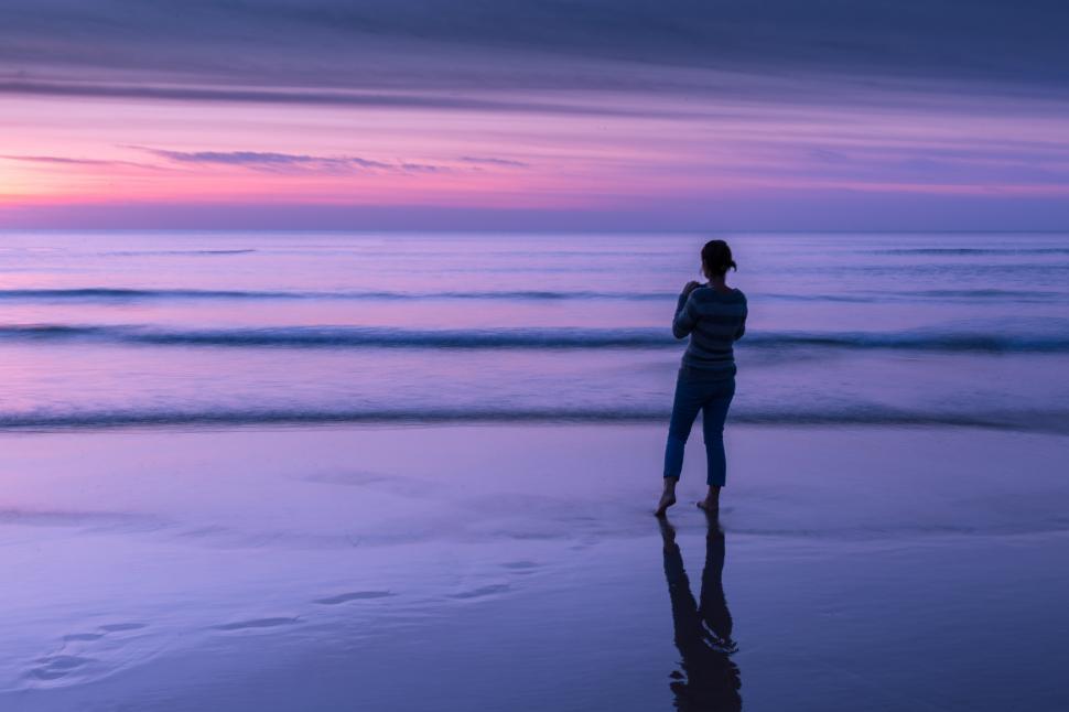 Free Image of A woman standing on a beach 