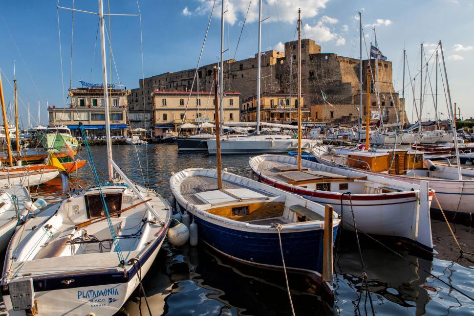 Free Image of Boats in a harbor with a castle in the background 