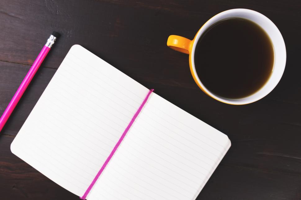 Free Image of A notebook and a cup of coffee 