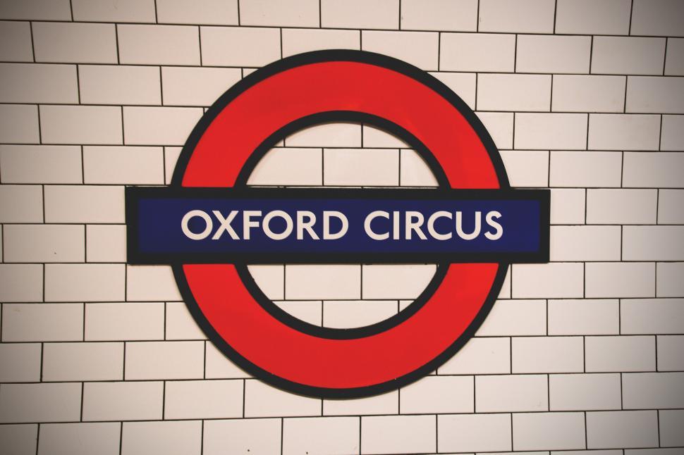 Free Image of A sign on a wall with london underground in the background 