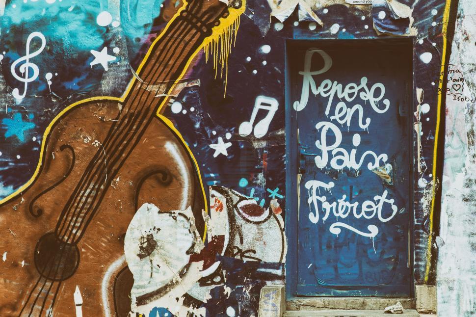 Free Image of A Paris, France blue door with a guitar and notes on it 
