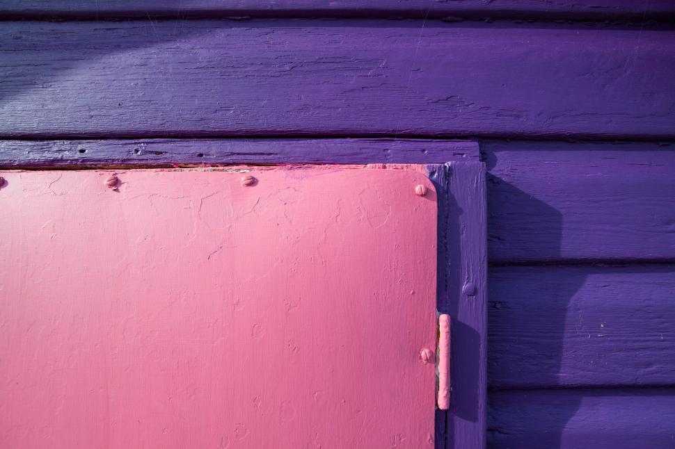 Free Image of A pink door on a purple wall 