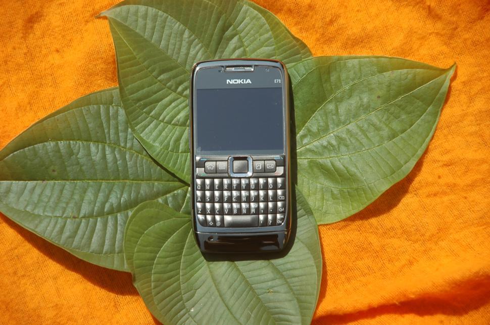 Free Image of Cell Phone on Green Leaf 