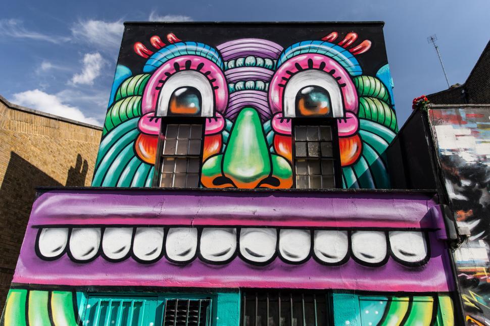 Free Image of A building with a colorful face painted on it 