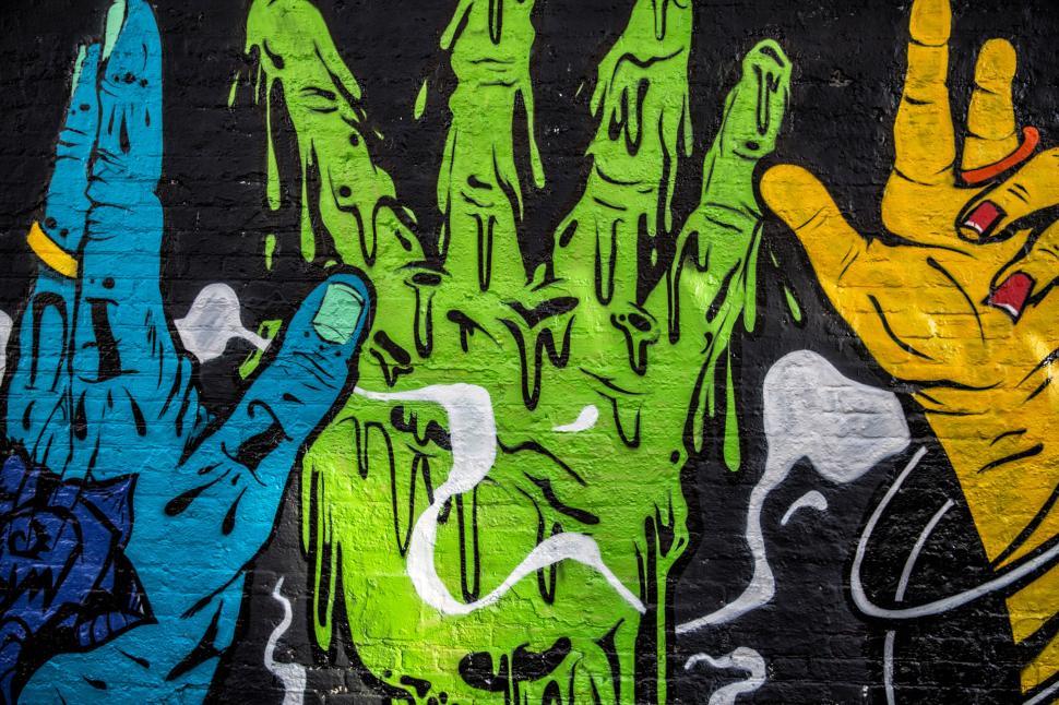 Free Image of A graffiti of a hand among other hands 