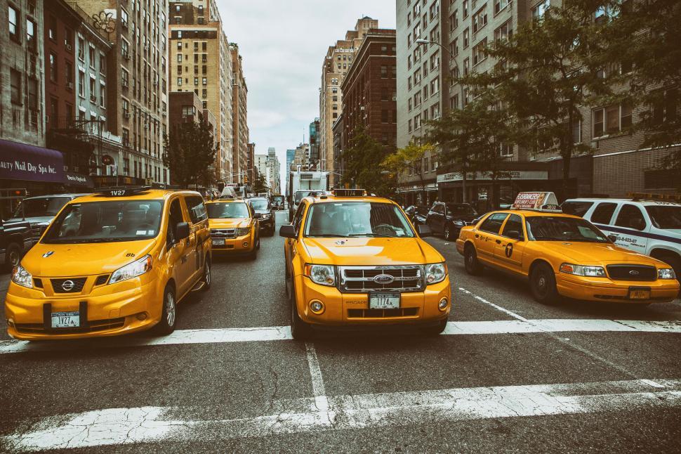 Free Image of A group of yellow taxi cabs in a city street 
