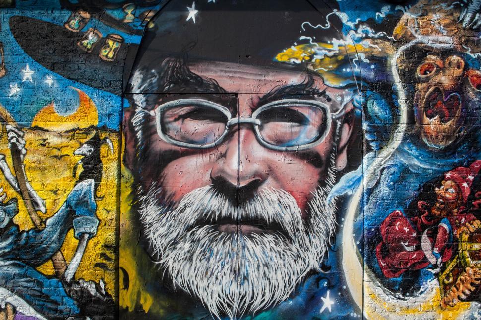 Free Image of A mural of a man with glasses and a beard 
