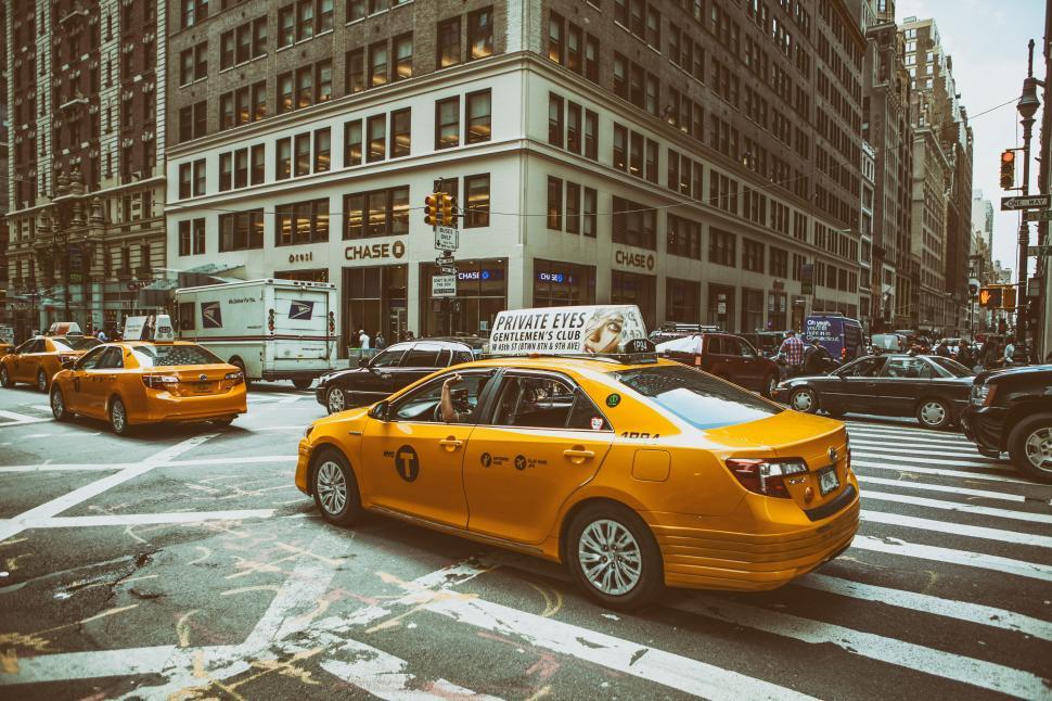 Free Image of A yellow taxi on a street 