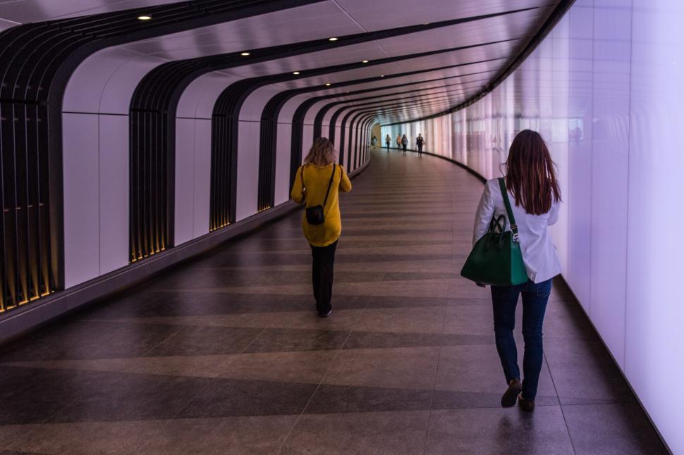 Free Image of Two women walking in a tunnel 