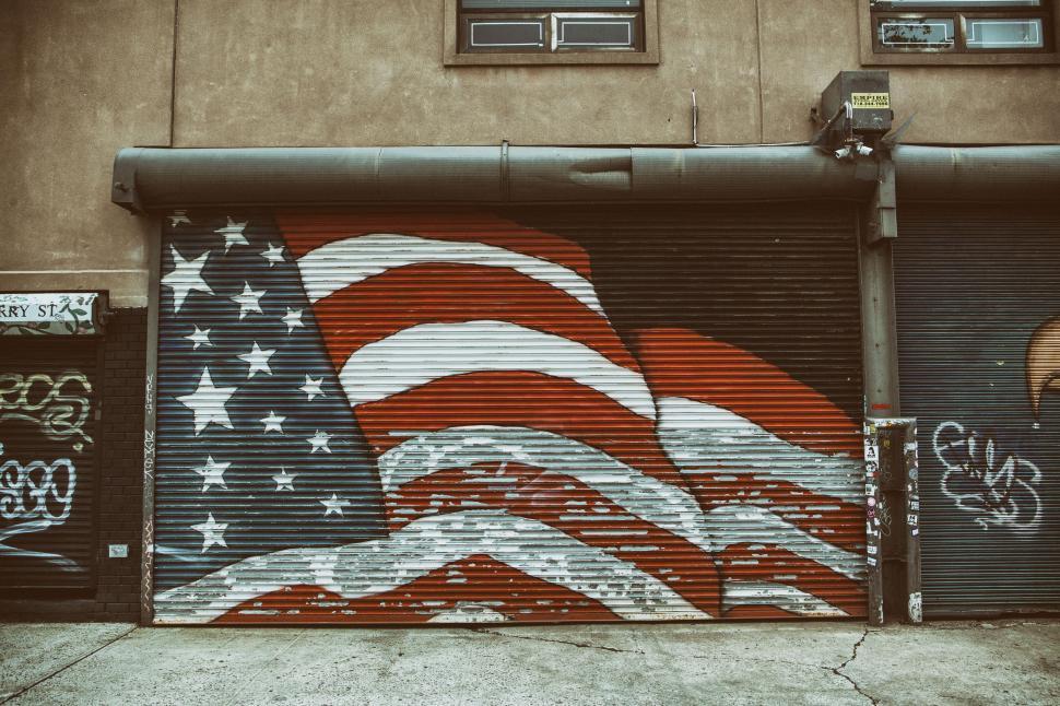Free Image of A flag painted on a garage door 
