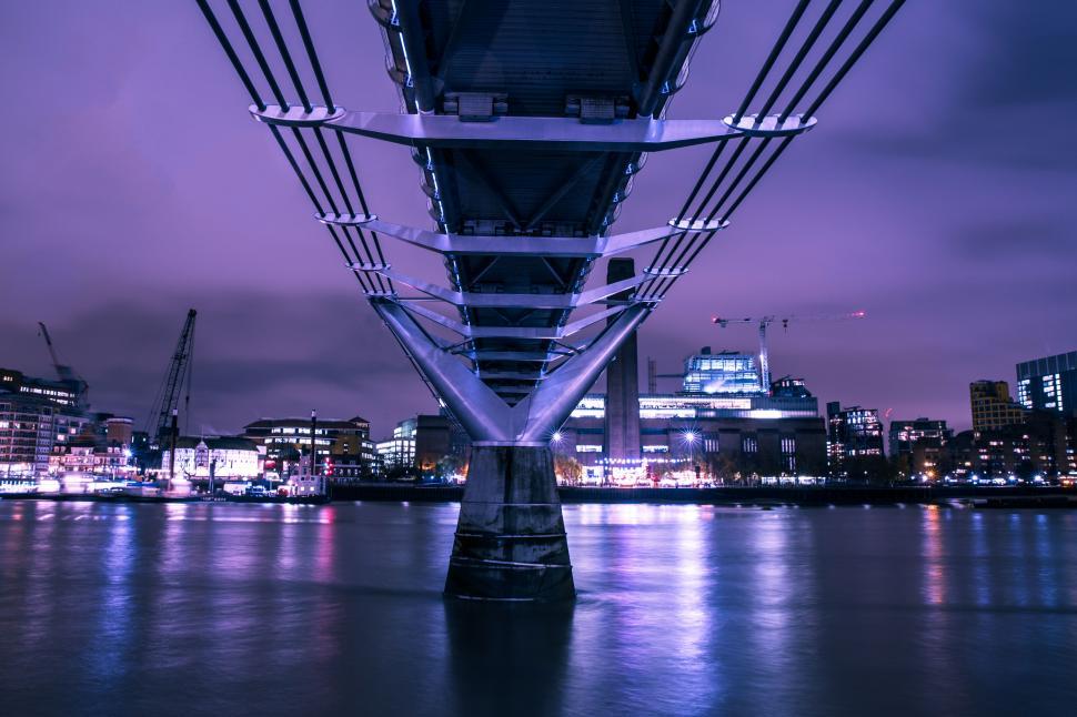 Free Image of A bridge over water with buildings in the background 
