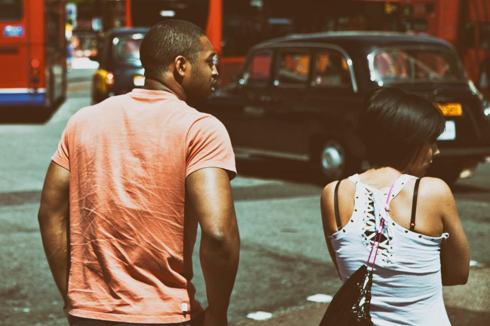 Free Image of A man and woman standing on a street 