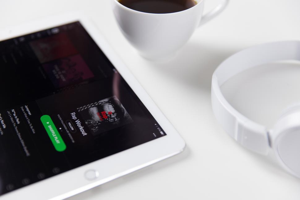 Free Image of A white tablet next to a cup of coffee 