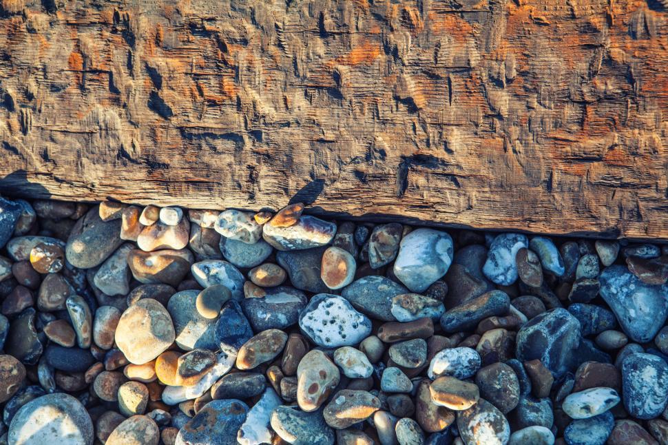 Free Image of A group of rocks and a piece of wood 