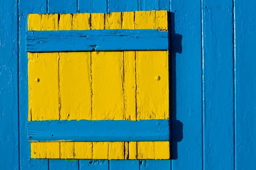 Free Image of A yellow and blue wood panel 
