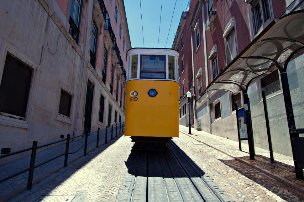 Free Image of A yellow trolley on a street 