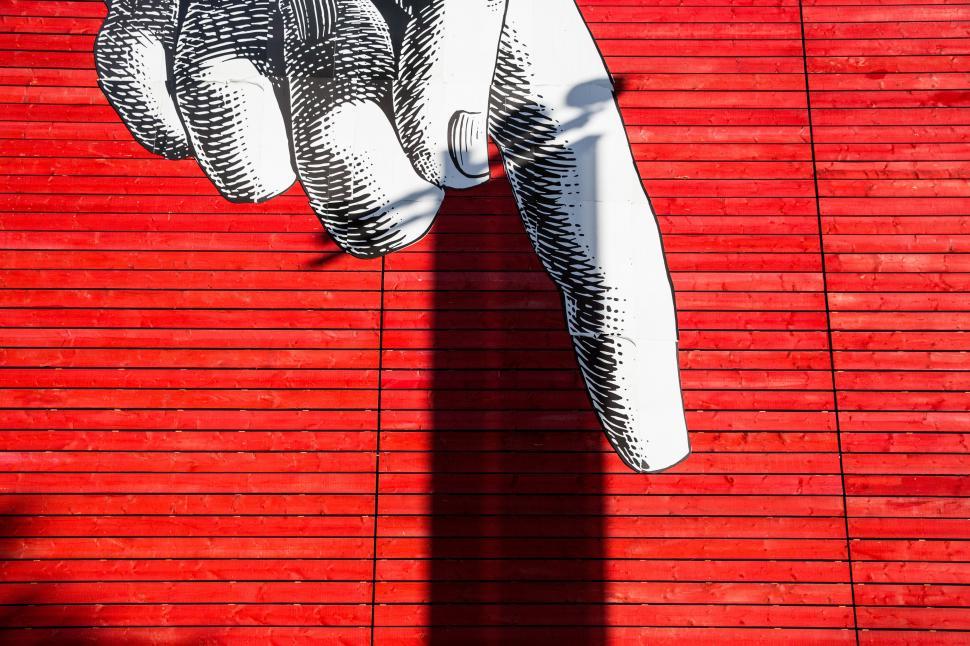 Free Image of A painted hand on a red wall 