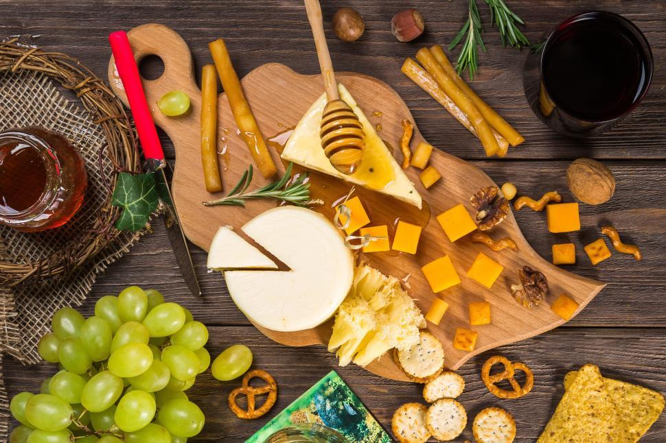 Free Image of A cheese board with grapes and nuts 