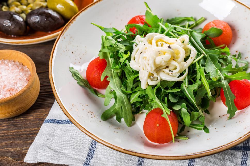 Free Image of A plate of salad with tomatoes and squid rings 