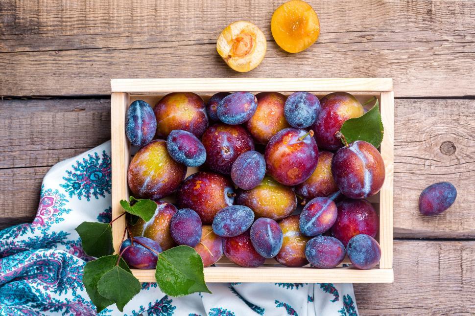 Free Image of A wooden box of plums 