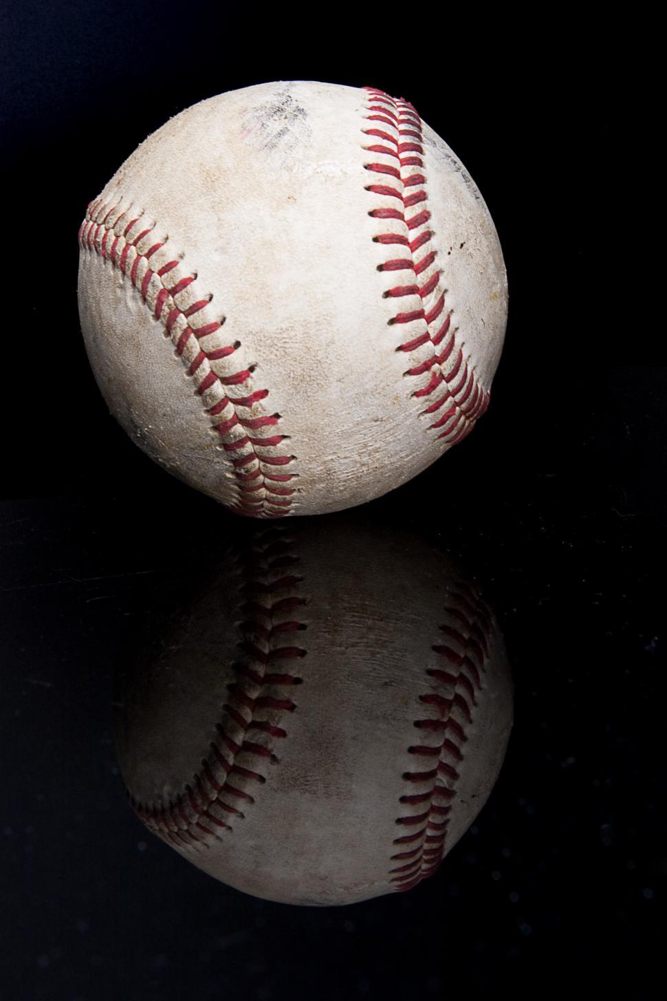 Free Image of Baseball on Black Surface 