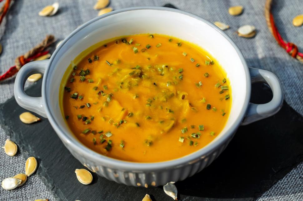 Free Image of A bowl of soup with green onions and pumpkin seeds 