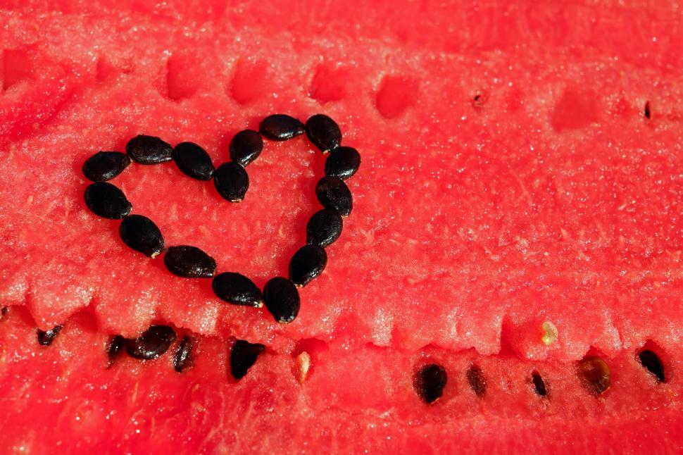 Free Image of A heart made out of seeds on a watermelon 