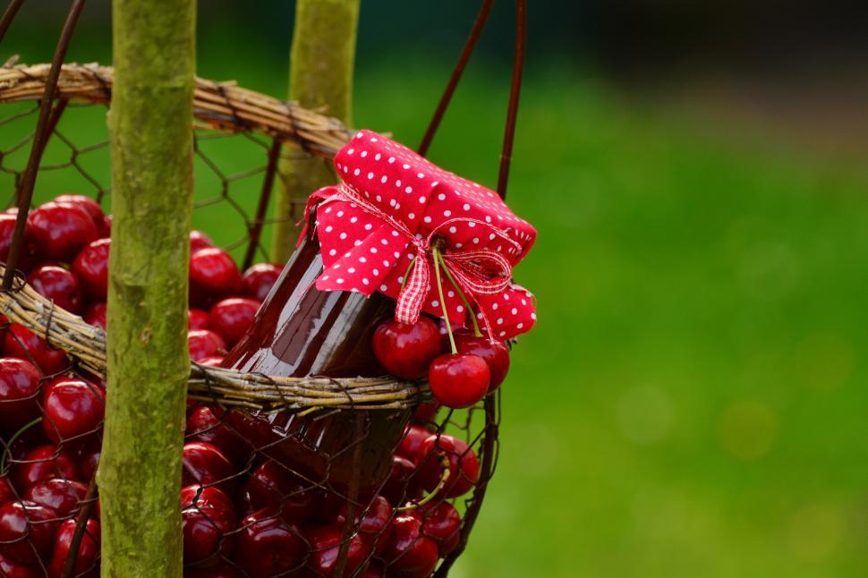 Free Image of A basket of cherries and a jar of jam 