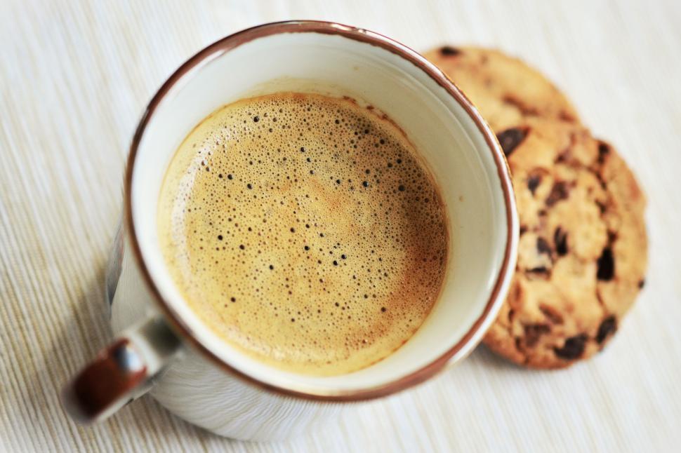 Free Image of A cup of coffee and a cookie 