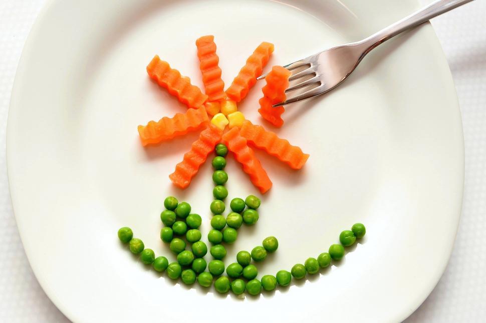 Free Image of A plate with a flower made of vegetables 