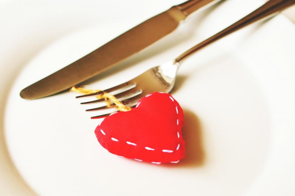 Free Image of A fork and knife with a heart shaped object 