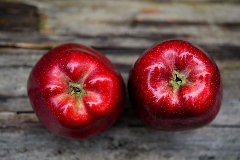 Free Image of Two apples on a wood surface 