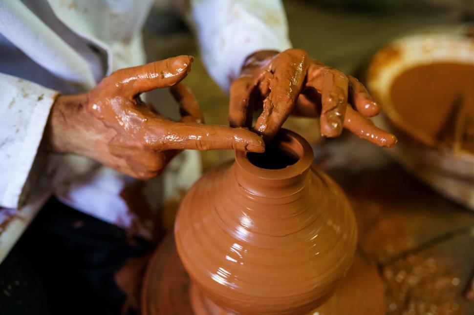 Free Image of Craftsman moulding a piece of pottery on an Arab potter s wheel. 