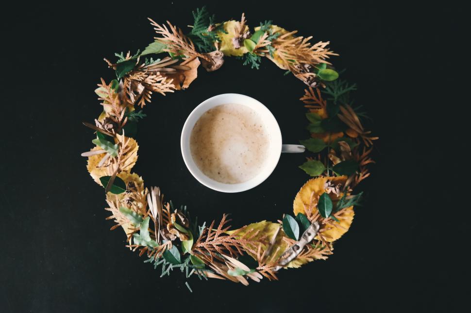 Free Image of A cup of coffee in a wreath of leaves 