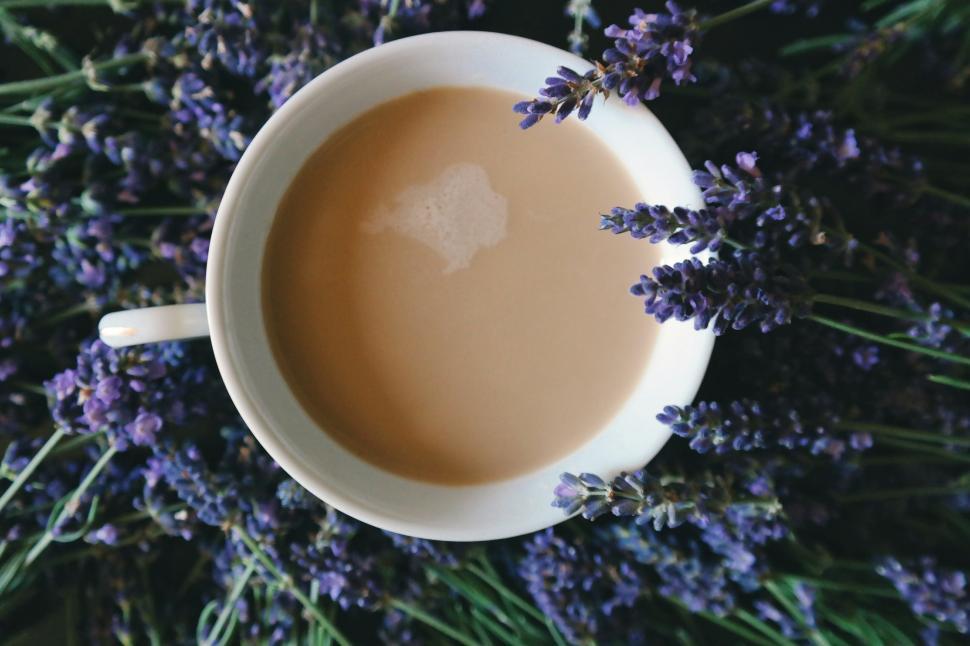 Free Image of A cup of coffee surrounded by lavender 