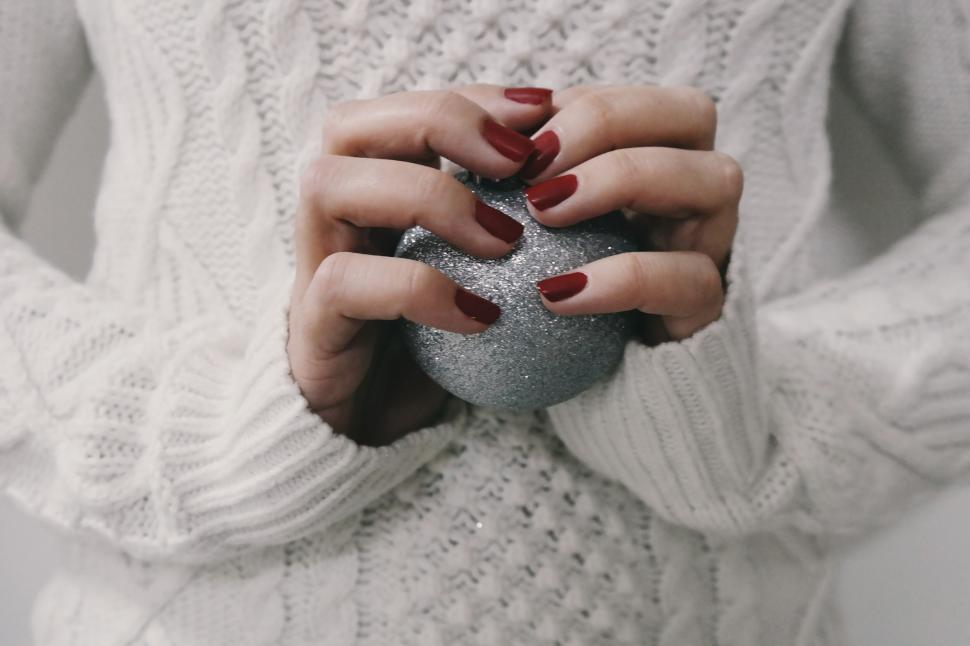 Free Image of A woman holding a glittery ball 