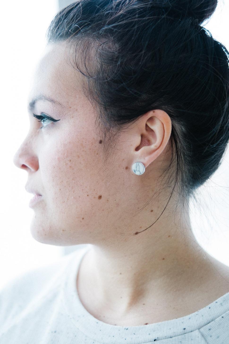 Free Image of A woman with a white earring 