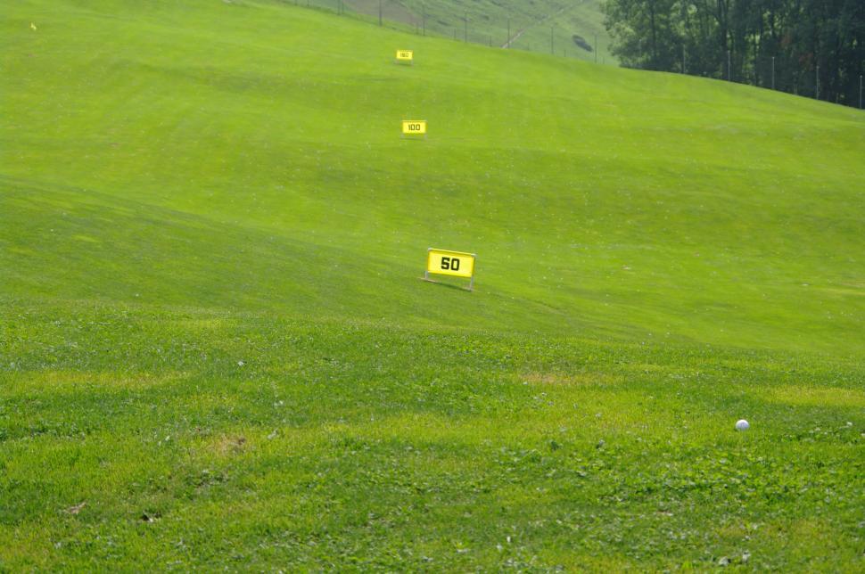 Free Image of Green Golf Course With Yellow Markers 
