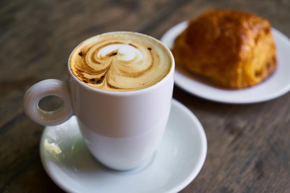 Free Image of A cup of coffee and a croissant 