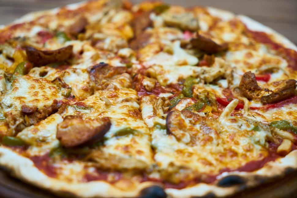 Free Image of A pizza with sausages and peppers 