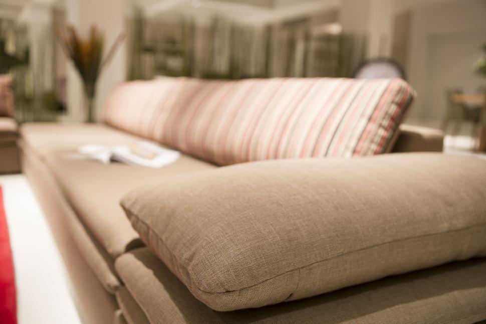 Free Image of A couch with a striped pillow 