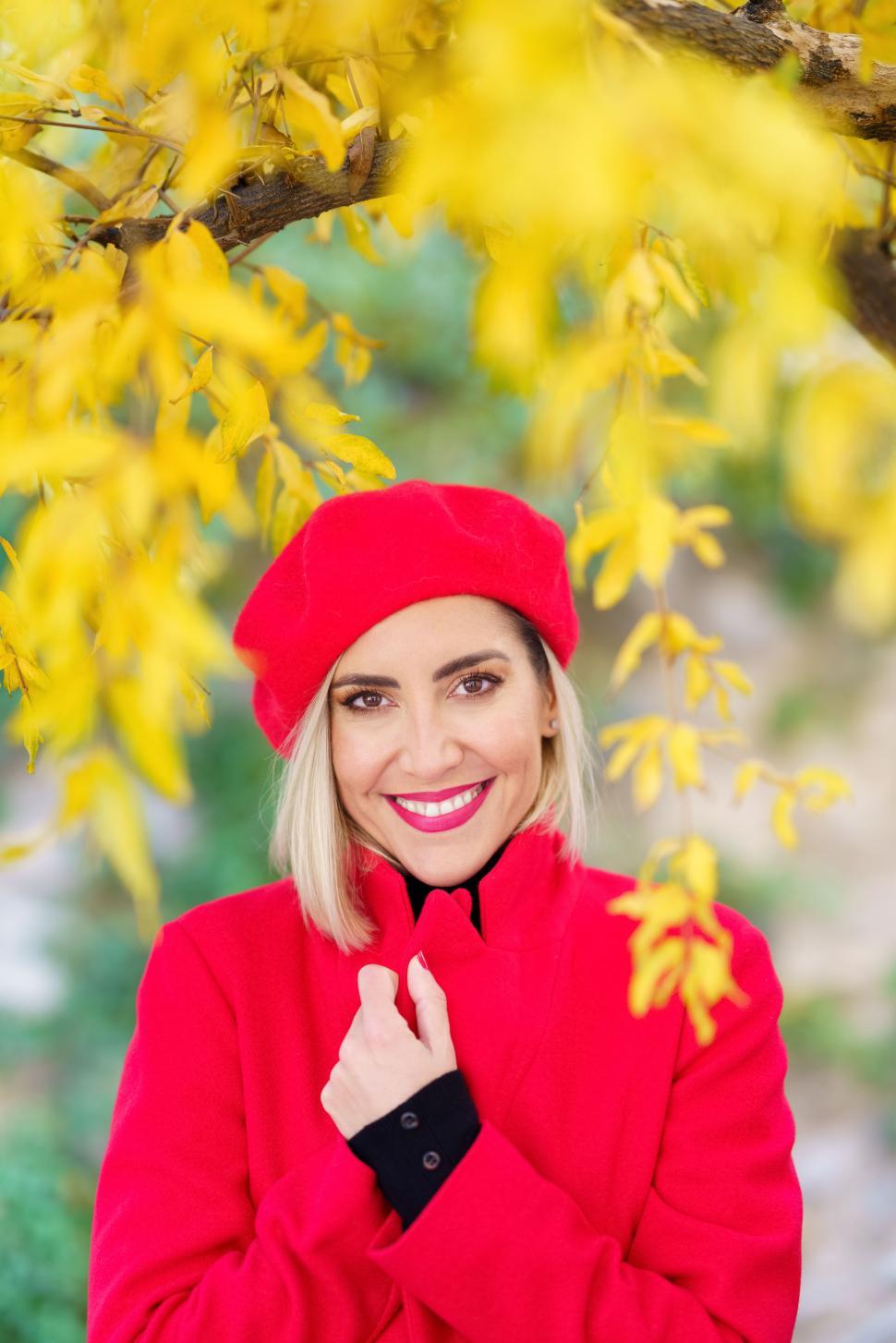 Free Image of Excited graceful female smiling in autumn park in sunlight 