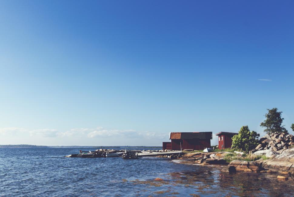 Free Image of A body of water with a building and a dock 