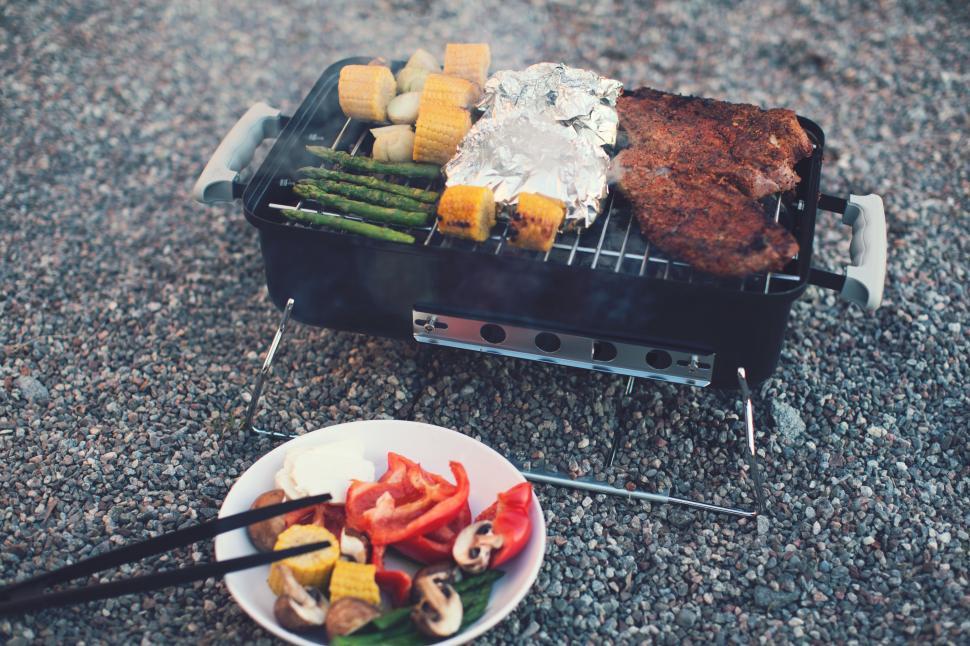Free Image of A grill with meat and vegetables on it 