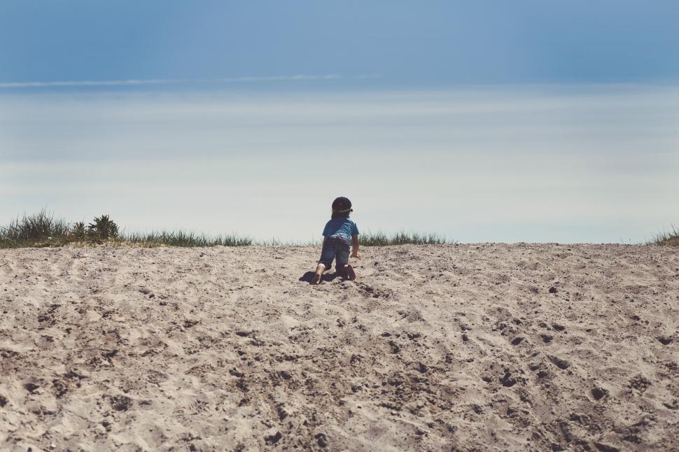 Free Image of A child playing in the sand 