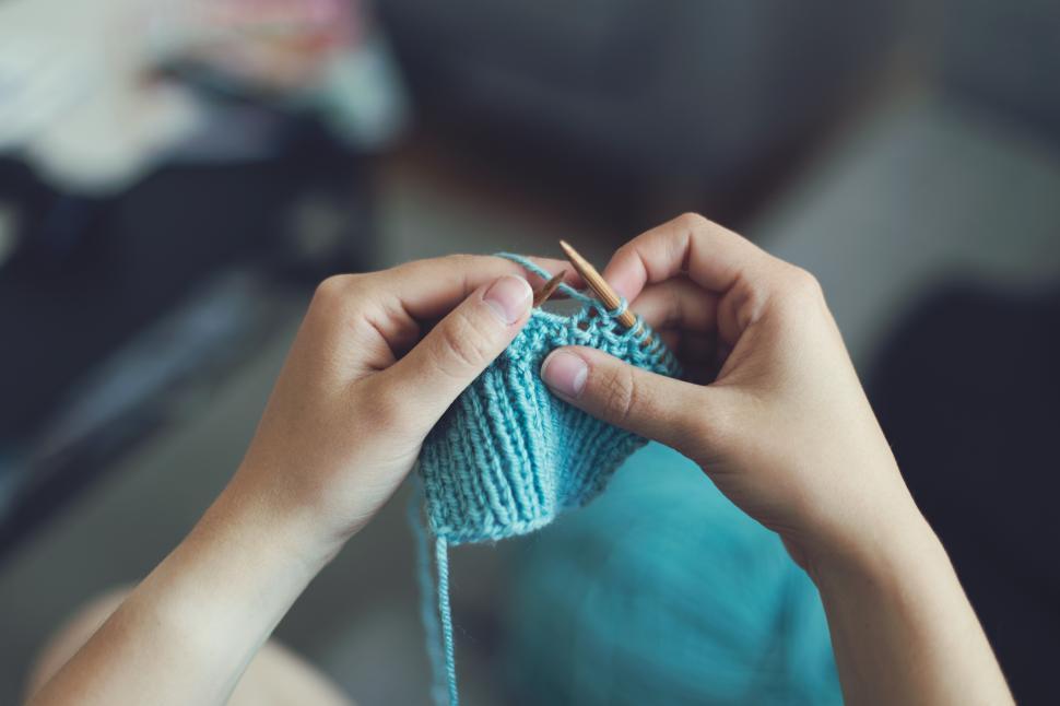 Free Image of A person knitting a blue piece of yarn 