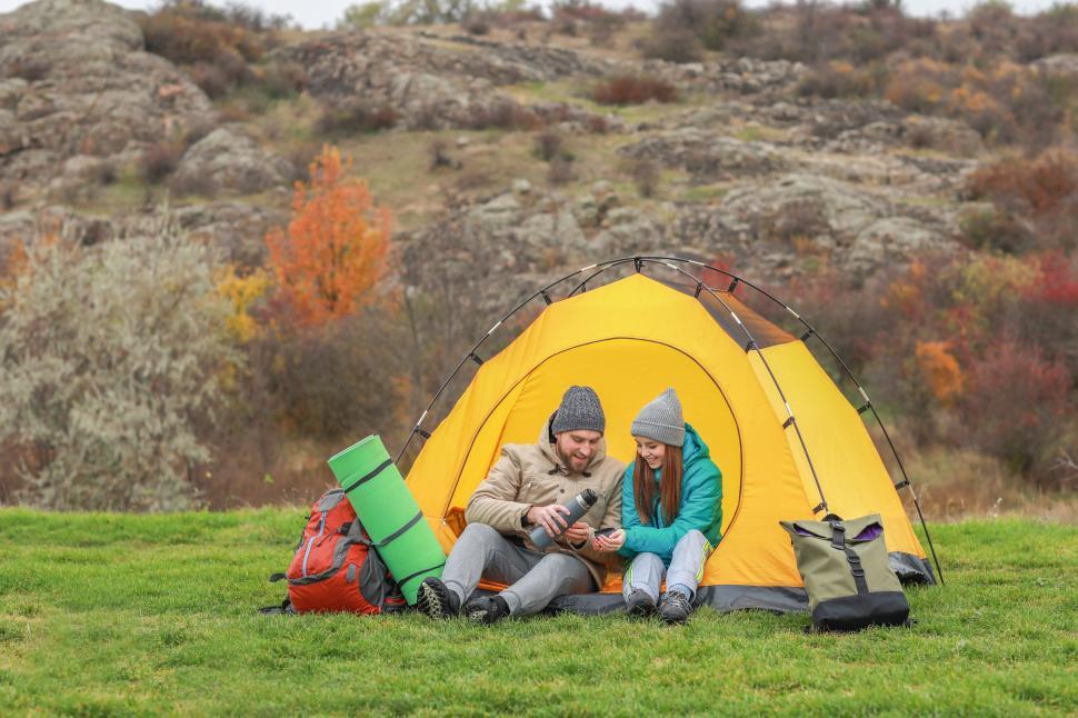 Free Image of A man and woman sitting in a tent 
