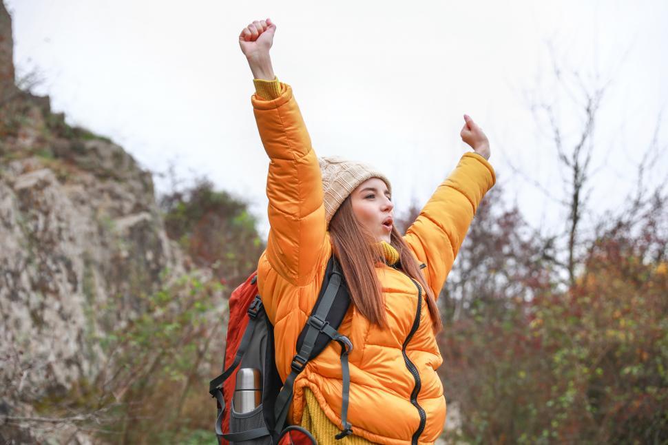 Free Image of A woman with her arms raised in the air 